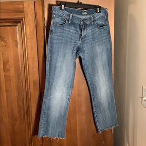 Ankle cropped bootcut jeans with distressed hem